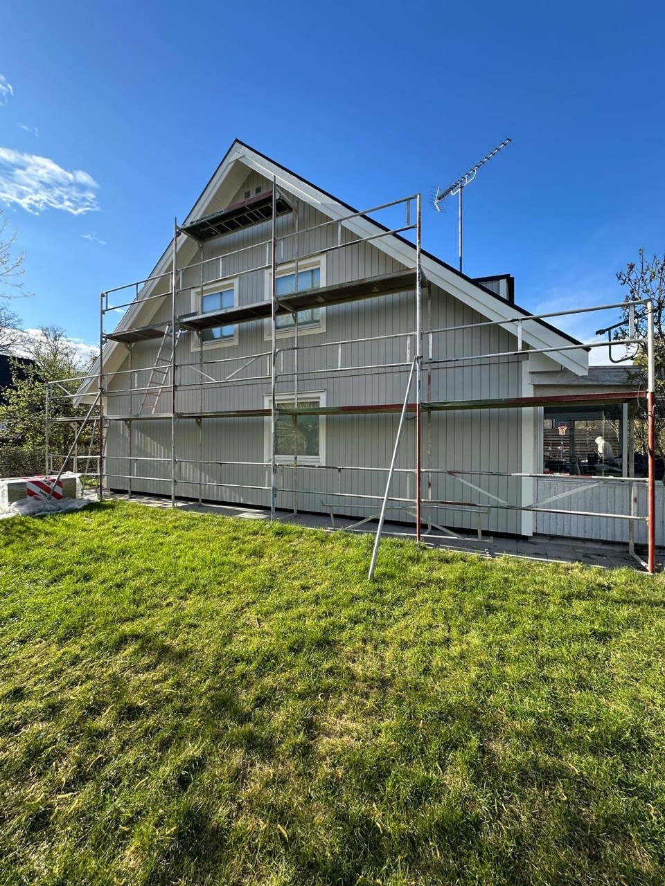 Full house exterior with scaffolding during the renovation phase