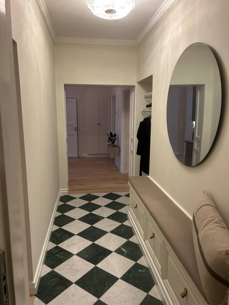 Marble checkerboard hallway after wall demolition
